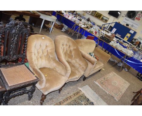 A late Victorian harlequin three piece suite comprising two button back chairs and a drop end sofa