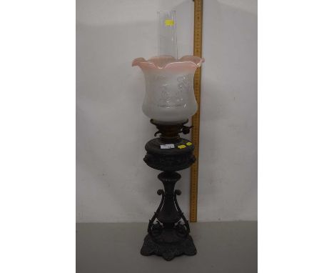 Cast metal based Victorian oil lamp with frosted glass shade