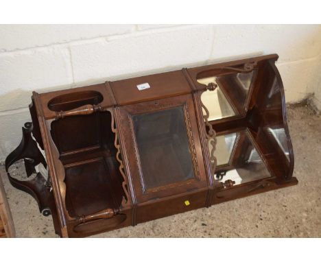 An Edwardian mahogany corner shelf with mirrored panels