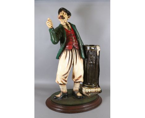 A composite figural stick/umbrella stand formed as a 1920s gentleman golfer bearing signature Peter Mook.