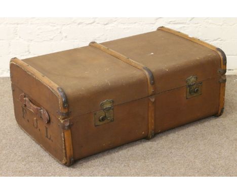 A metal and wooden bound canvas travel trunk.