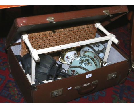 An old suitcase and contents including two brass based tablelamps and a painted alluminium wall light.