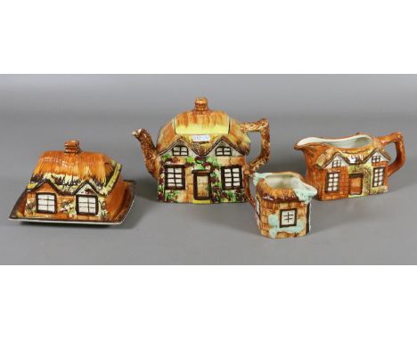 A selection of cottageware, including teapot, sauce boat, butter dish and milk jug.