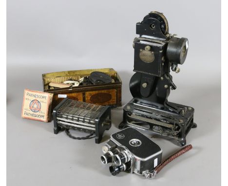 A Bolex Paillard vintage cine camera with three interchangeable lenses along with nine Pathescope cine projector and a tin of