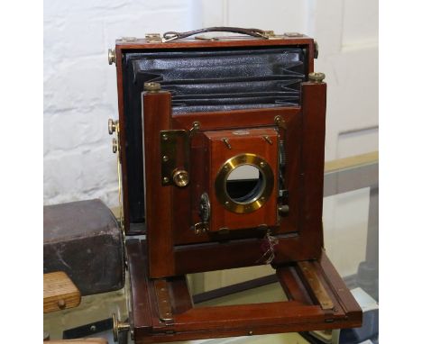 An antique leather cased brass and mahogany bellows camera by Reynolds and Branson Ltd 14 Commercial Street Leeds with 'Time 