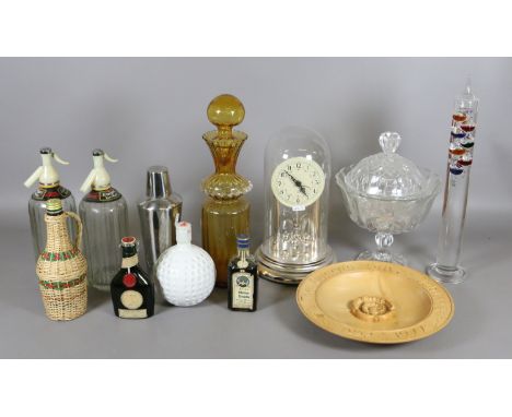 A collection of glassware including soda syphons, thermometer, anniversary clock, Italian glass bottle and sealed liqueurs, e