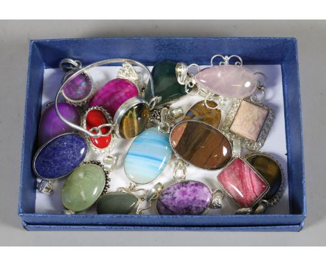 A good collection of silver and hardstone brooches and a bangle including tigers eyes, rose quartz and jade examples, etc.