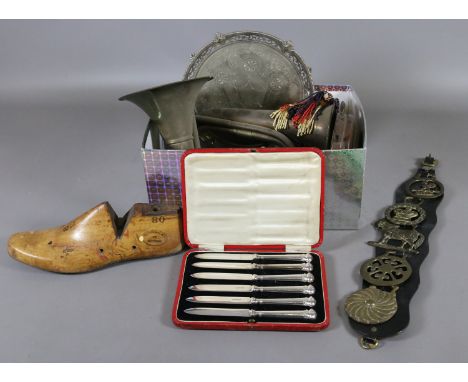 A box of metalwares including horse brasses, barometer, cased silver plated butter knives, plated salver and bugle, etc.