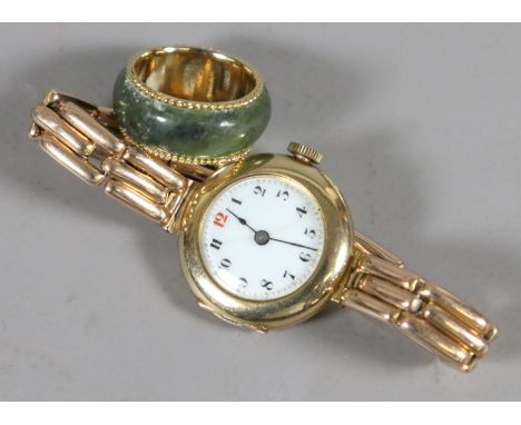 A ladies 9 carat gold wristwatch along with a jade ring.