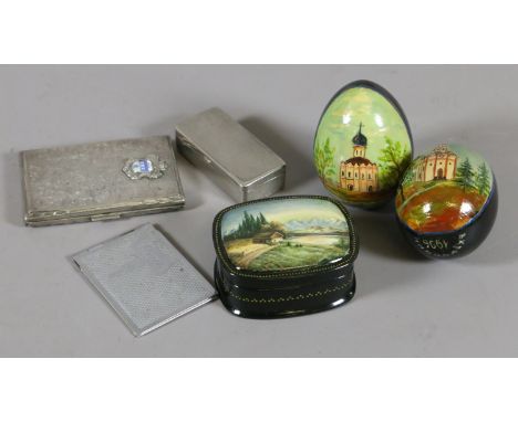 A white metal cigarette case and stamp case along with two handpainted Russian eggs and a similar trinket box.