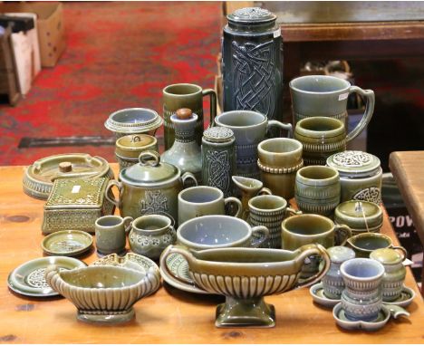 A large collection of Wade Celtic porcelain including tobacco jar, storage jars, trinket box, cups, cruet set and vases, etc.