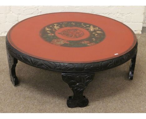 A mid 20th century Japanese lacquer low circular tea ceremony table raised on bracket supports and carved with stylized peony