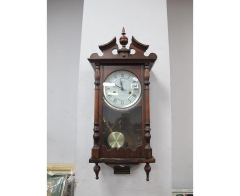 A Lincoln 31 Day Wall Clock, with a swan neck pediment, glazed door, circular dial, Roman numerals.