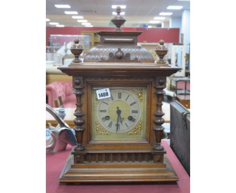 A Late XIX Century Walnut Cased Mantel Clock, with turned finials silvered dial, with Roman numerals, stepped base.