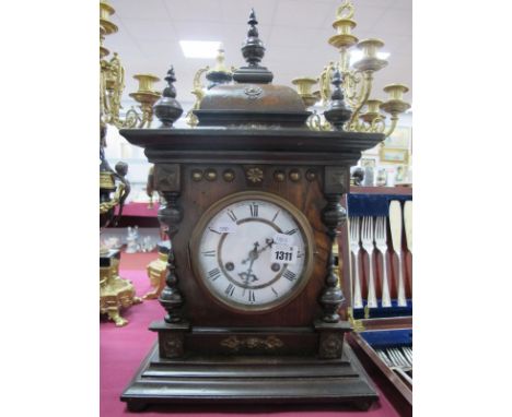 A XIX Century Mantel Clock, with turned finial's, enamel dial, Roman numerals, on a stepped base, 53cm high.