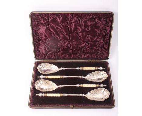 A cased set of four Victorian serving spoons with engraved ovoid silver plated bowls and spiral reeded ivory handles