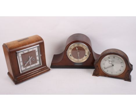 A 1930s walnut cased mantel clock with eight-day striking movement and two similar mantel clocks, one with silvered dial