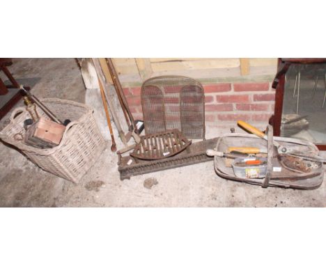 A collection of garden tools, a shoe last, etc, in basket and trug