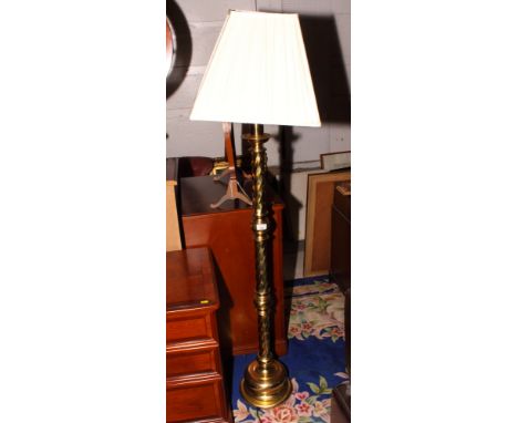 A brass standard lamp on spiral reed column and circular base and a mahogany canterbury