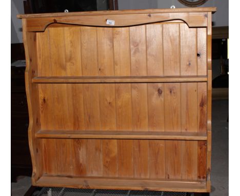 A pine wall shelf with boarded back, 38" wide, and a single bedstead with cream painted tubular metal ends