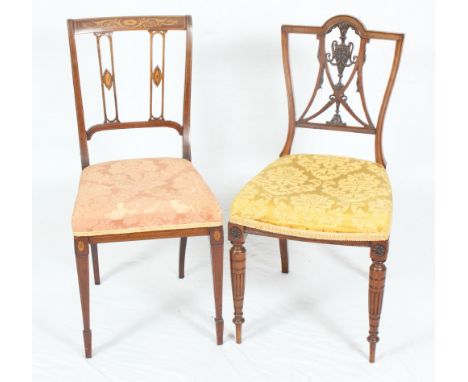 A pair of Victorian walnut salon chairs with carved and pierced back splats, seats upholstered in a gold tapestry, on turned 