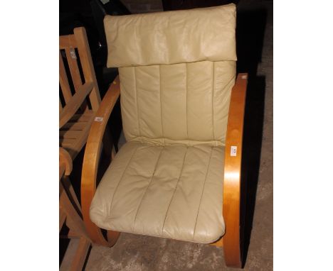 A light bentwood framed open armchair with cream leather upholstery and a rubberwood dining table