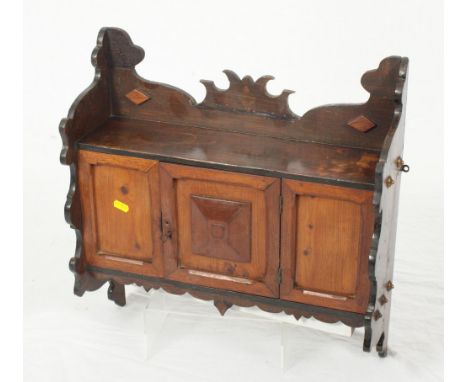 A late 19th Century "Gothic" design pine wall hung cupboard fitted shelf over, 19" wide, and a nest of three walnut occasiona