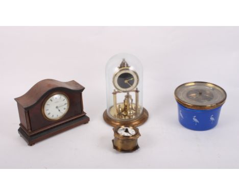 An Edwardian figured mahogany and brass mounted mantel clock with white enamel dial, a 400-day clock, a German alarm clock an
