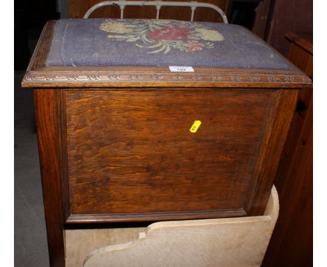 An oak rectangular box seat stool with floral tapestry top and a dark stained wooden hall chair, back pierced trefoil