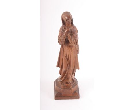 A carved wood figure of a standing lady with hands clasped, 9" high, and two travelling chess sets