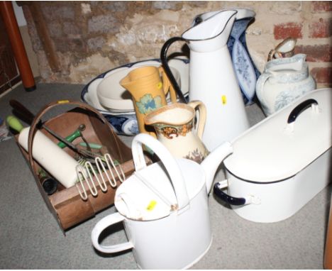 A white enamel fish kettle, enamel jugs and other decorative ceramic jugs