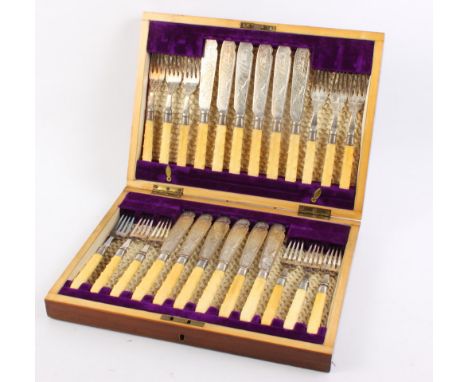 A set of twelve pairs of silver plated fish knives and forks, in mahogany canteen