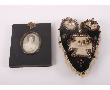 A 19th Century oval miniature print, portrait of Miss Croker, in ebonised frame, and a heart-shaped pin cushion