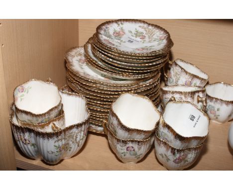 A late Victorian floral decorated part tea service with gilt rims, comprising ten cups and saucers, twelve side plates, a lar