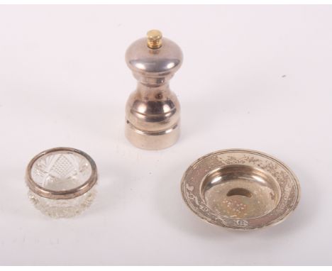 A silver Armada dish, a silver pepper grinder and a cut glass salt with silver mount