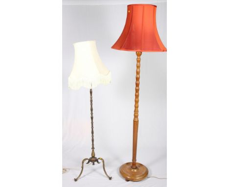 A polished as walnut standard lamp and a brass standard lamp, on splay supports