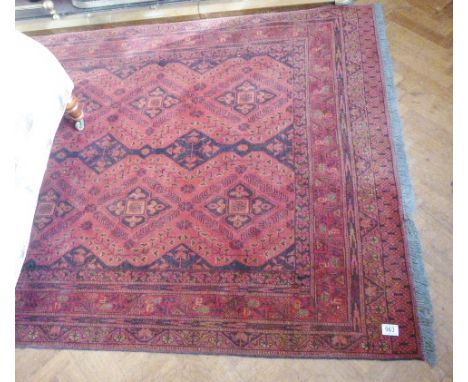 RED AND BLACK PERSIAN CARPET. Woolen fringed carpet in red and black design 128 X 196cm