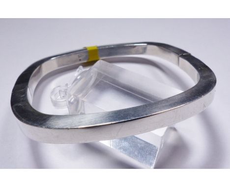SILVER HINGED BANGLE. Sterling silver cushion shaped hinged bangle