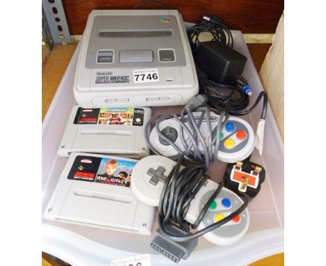SUPER NINTENDO AND GAMES. Super Nintendo console with two controllers, associated wires and two loose games