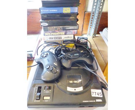 SEGA MEGA DRIVE AND GAMES. Sega Mega Drive console with two controllers and associated wires plus seven boxed games and four 