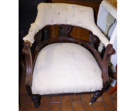 UPHOLSTERED CHAIR. Upholstered low carved chair on ceramic castors