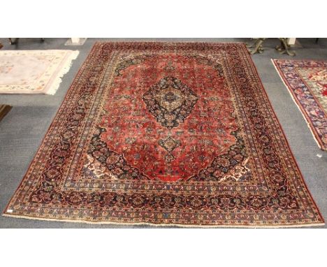 A large Persian Kashan traditional hand woven wool carpet (231cm x 324cm) some wear