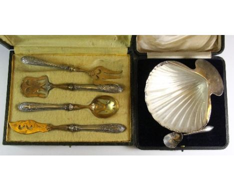 A hallmarked silver cased shell butter dish and sugar scoop together with a French silver handled and gilt serving set