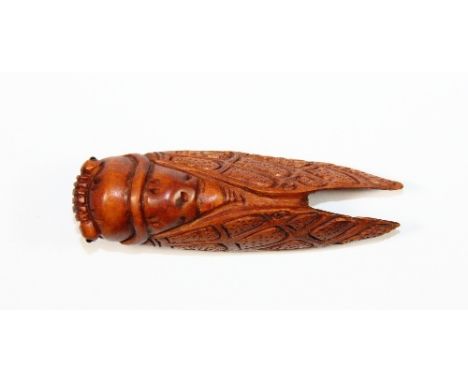 A very detailed carved fruitwood netsuke of a cicada.