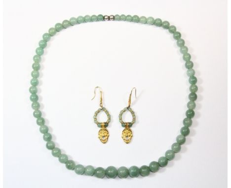A single strand necklace of celadon green jade graduated beads together with a pair of gilt and jade earrings