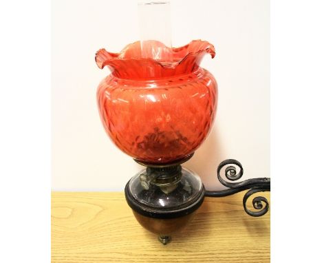 A Victorian wall mounted wrought iron, copper and glass oil lamp