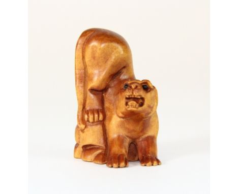 Carved signed fruitwood netsuke of a tiger with black onyx eyes