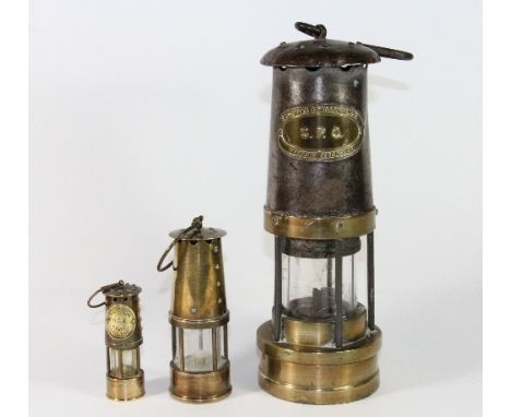 A GPO miners style lamp and two other miniature miners lamps