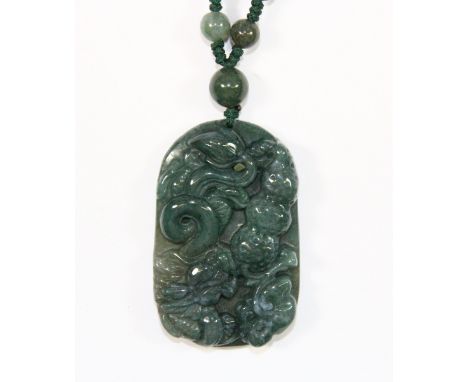 A Chinese spinach jade/hardstone dragon amulet and beaded necklace