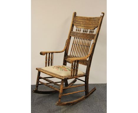 A tapestry upholstered American style rocking chair